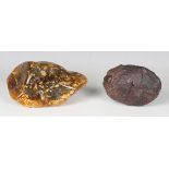A polished specimen of amber, length 15cm, together with a lava rock, possibly Sahara Dessert,