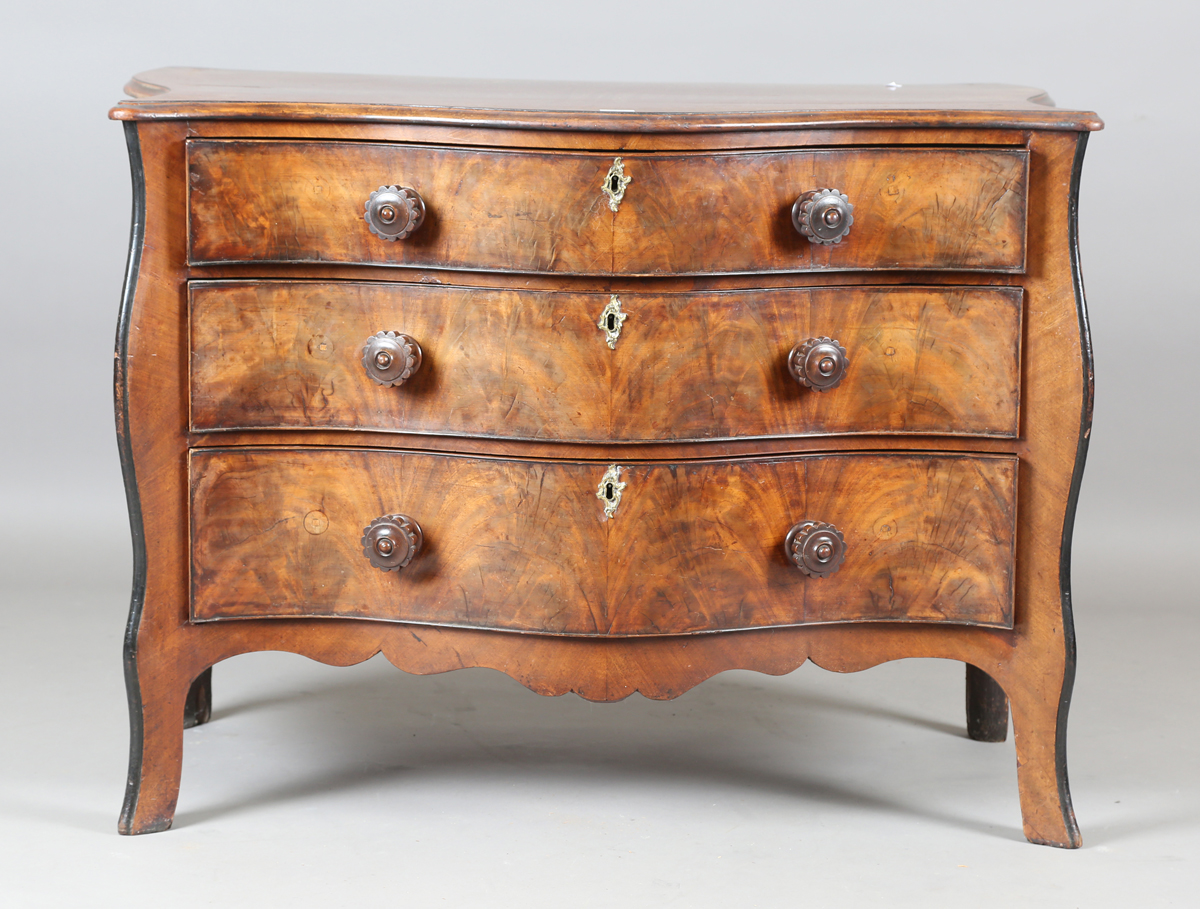 An 18th century and later mahogany serpentine fronted chest of three drawers with later carved