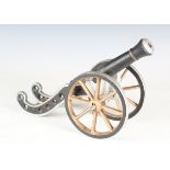 An early 20th century cast iron scale model of a cannon with later painted decoration, width 35cm.