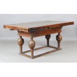 A 17th century and later oak draw-leaf dining table, the thick rectangular top above a deep frieze