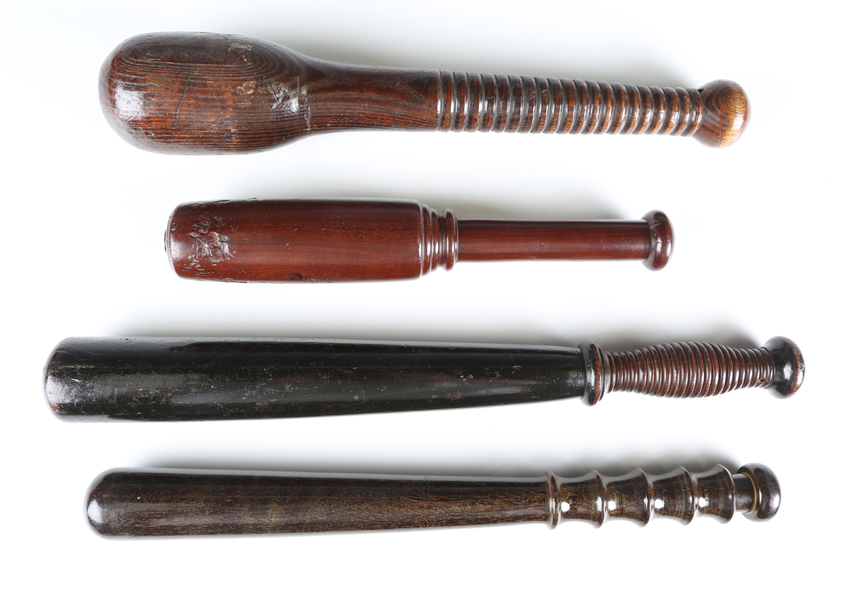 A Victorian ebonized wooden policeman's truncheon of tapering form with a shaped ribbed handle,