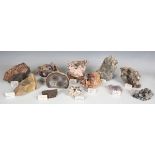 A collection of mineral specimens, including rutilated quartz, chalcanthite, adamite, carborundum,