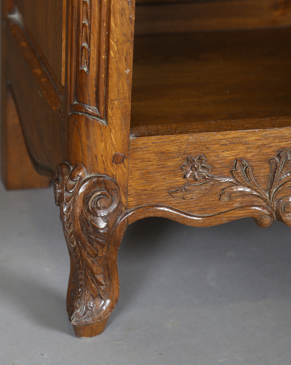 A pair of late 20th century French oak bedside cabinets, each fitted with a finely carved drawer and - Image 5 of 17