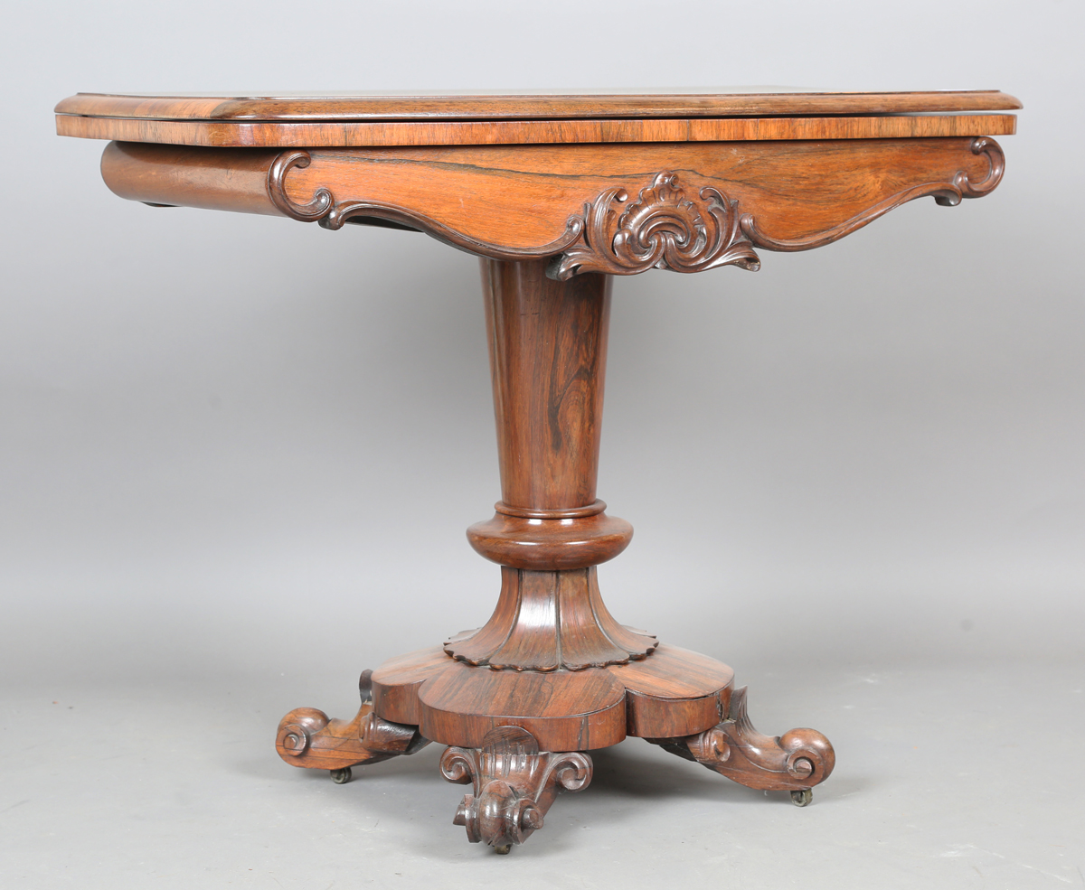 An early Victorian rosewood fold-over tea table, the frieze with applied foliate carved