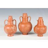 A Roman red slip pottery two-handled flask, 4th century AD, the globular body sprigged with a