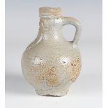 A medieval salt glazed pottery Bellarmine jug, 16th/17th century, the body covered in a grey glaze