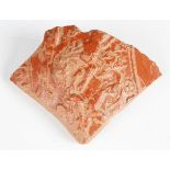 A Roman Samian ware fragment, decorated in relief with a lion attacking a figure, 11cm x 8.5cm.