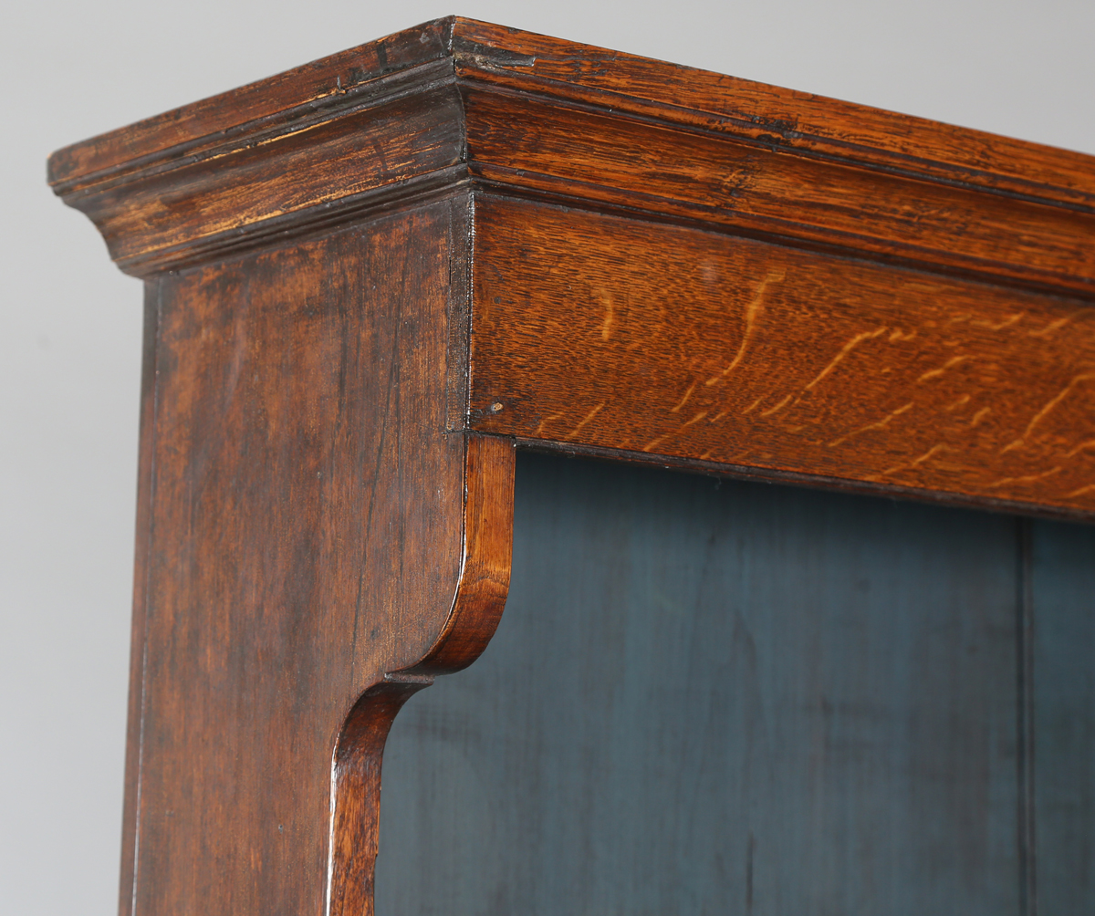 A late George III provincial oak dresser, the shelf back with blue painted backboards, the base with - Image 9 of 9