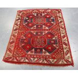 A Kazak rug, West Caucasus, early 20th century, the red field with two bold octagonal flowerhead