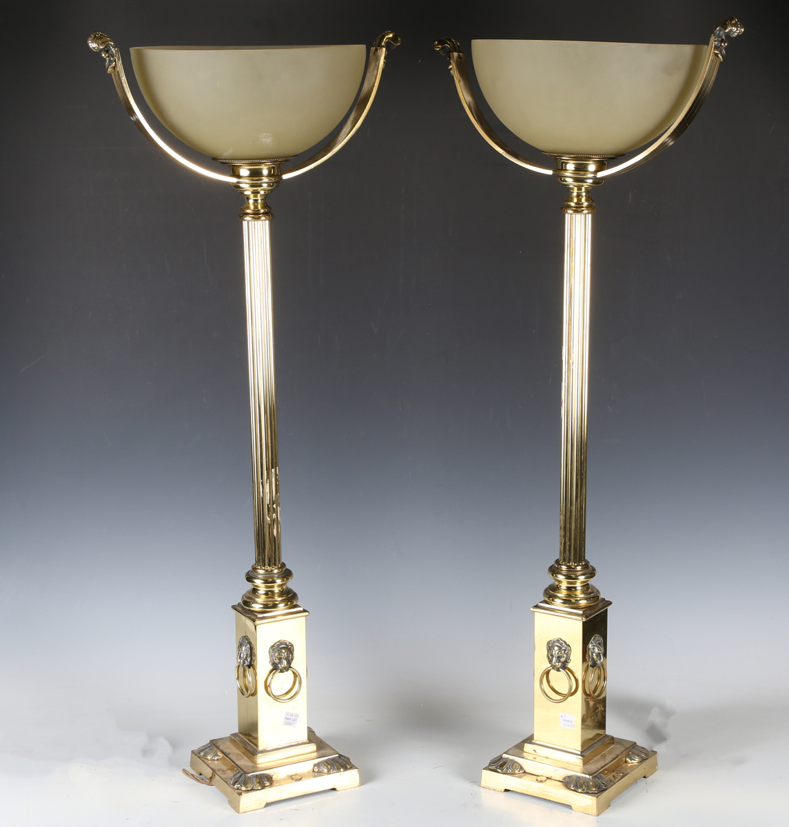 A pair of late 20th century Victorian style gilt brass table lamps, each with an opaque glass