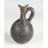 A Greek black pottery flask with flared neck and loop handle, height 13.5cm (faults). Provenance: