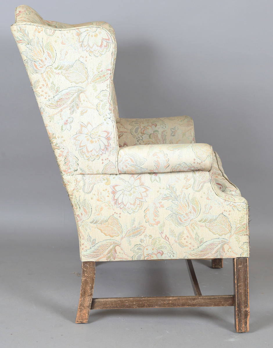 A 20th century George III style wingback armchair, upholstered in foliate machined tapestry style - Image 5 of 12