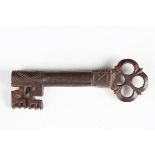 A 16th century wrought iron key with incised shaft and pierced quatrefoil finial, length 9cm.Buyer’s