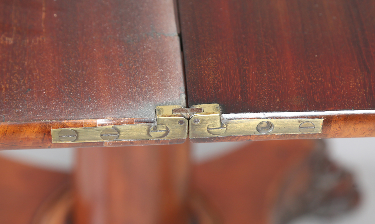 A George IV mahogany fold-over tea table, raised on a turned column and quatrefoil base, height - Image 7 of 9