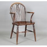 A 19th century ash and elm Windsor armchair with wheel back and 'H' stretcher, height 90cm, width