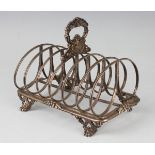 An early Victorian silver six-division toast rack with central scallop shell and foliate decorated