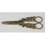 A pair of late Victorian silver gilt grape shears, each handle cast in relief with fruiting vines,