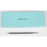 A Tiffany & Co sterling silver ballpoint pen with engine turned decoration, with original