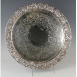 A Victorian silver circular salver, the centre engraved with a band of fruiting vine, the cast and