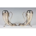 A pair of late Victorian silver cornucopia shaped sugar casters, each with pierced dome cover,