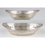 A pair of late Victorian Scottish silver oval bonbon baskets, each with beaded rim above pierced and