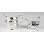A George III silver cream boat with beaded rim and flying scroll handle, on scroll legs