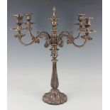 An early 19th century plated four-branch five-light candelabrum, each foliate scroll branch with urn