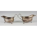 A pair of George V silver sauceboats, each with bellflower rim, on scroll legs, Birmingham 1926