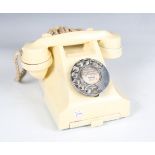 An early 20th century ivory Bakelite 300 series telephone with frieze drawer, the underside detailed