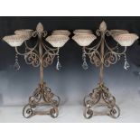 A pair of modern painted wrought iron four-light candelabra with glazed pottery sconces and cut