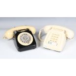 A mid-20th century cream and black plastic rotary telephone, the underside detailed '746F SPK 71/1',