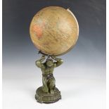 An early 20th century Geographia 10 inch terrestrial globe, held aloft by a green patinated