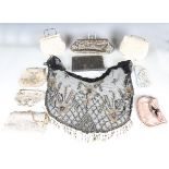 A collection of mainly mid-20th century beaded evening bags and a black beaded net shawl.Buyer’s