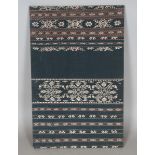 A Sumba Ikat panel, Indonesia, woven with overall bands of foliage, 79cm x 50cm.Buyer’s Premium 29.