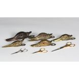 A group of five late 19th and early 20th century cast metal desk clips, four in the form of ducks'