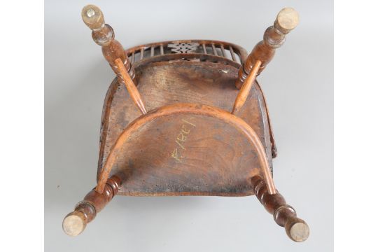 A mid-19th century yew and elm Windsor armchair with a pierced splat back and a crinoline stretcher, - Image 2 of 9