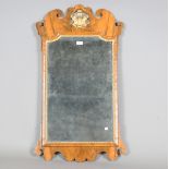 An early 20th century George III style walnut fretwork wall mirror, the shaped pediment with a