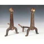 A pair of early 20th century cast iron and brass-heightened fire dogs, height 47cm, width 26cm,