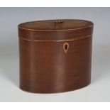 A late George III mahogany oval tea caddy, the hinged lid with an inlaid fan reserve, width 14.5cm.