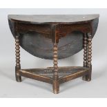 A Charles II oak circular single drop-flap credence style side table, raised on bobbin turned and