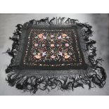 A 20th century Chinese black silk shawl, embroidered in polychrome silks with birds and flowers,