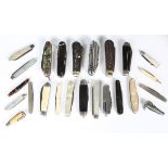 A collection of various pocket knives, including five mother-of-pearl folding fruit knives with