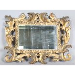 An 18th century Rococo giltwood rectangular wall mirror, the frame carved with large scrolling