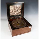 A late 19th century walnut cased Polyphon, playing 24.5cm discs, width of case 32cm, together with