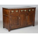 An 18th century oak dresser base, fitted with three drawers and two panelled doors, height 87cm,