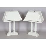 A pair of modern grey painted wooden table lamps with angular shades and twin column supports,