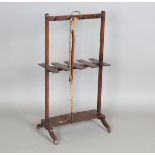 A George III mahogany boot and whip stand with gilt brass handle and shaped bracket feet, height