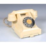 An early 20th century ivory Bakelite 300 series telephone with frieze drawer, the underside detailed