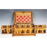 An Edwardian oak cased games compendium, the interior fitted with a chess set, height of king 6.5cm,
