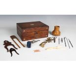 A Victorian rosewood box, containing various needlework accoutrements, including a brass clamp